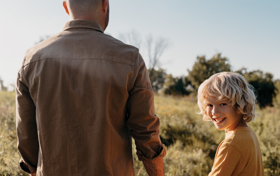 A father and son walking in a field