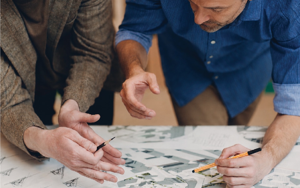 Two people looking over blueprints